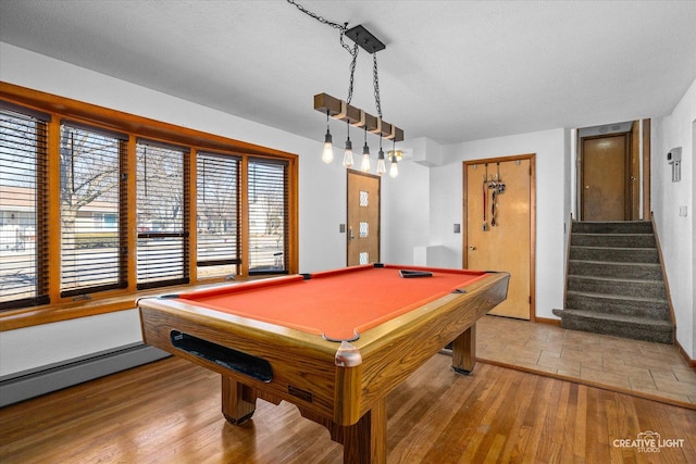 game room featuring light wood-style flooring, a baseboard heating unit, and billiards