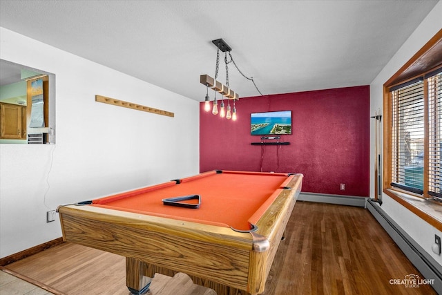 recreation room with a baseboard heating unit, baseboards, wood finished floors, and billiards