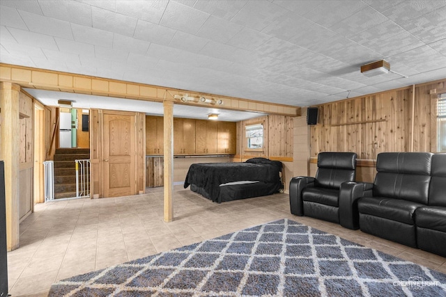 tiled bedroom featuring wood walls