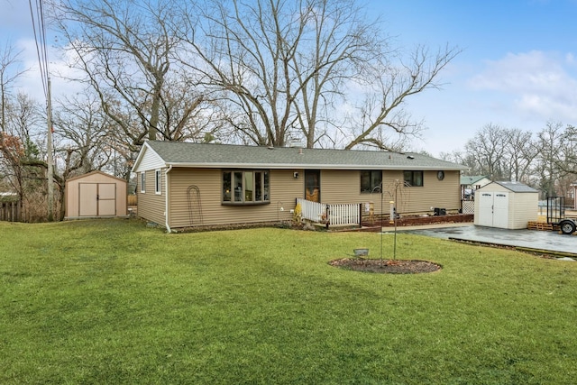 back of property with a yard, a storage unit, and an outdoor structure