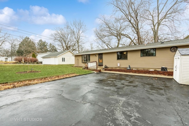 single story home with driveway and a front lawn