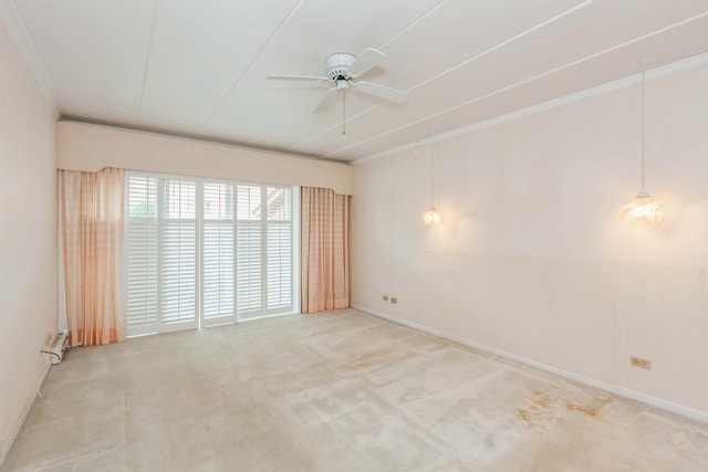 spare room with a ceiling fan, baseboards, and carpet floors
