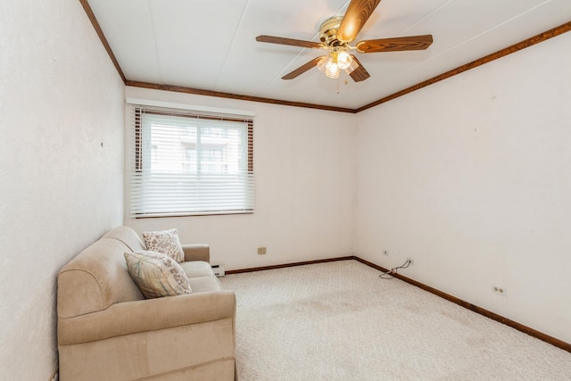 sitting room featuring baseboard heating, baseboards, carpet flooring, ceiling fan, and crown molding