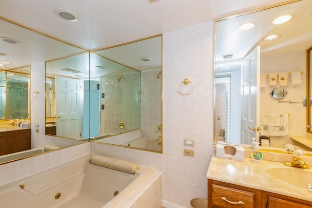 bathroom featuring tiled shower, a jetted tub, vanity, and visible vents