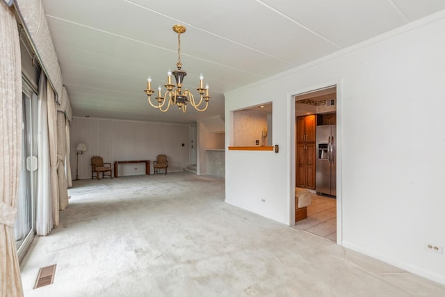 unfurnished dining area with ornamental molding, a chandelier, visible vents, and carpet floors
