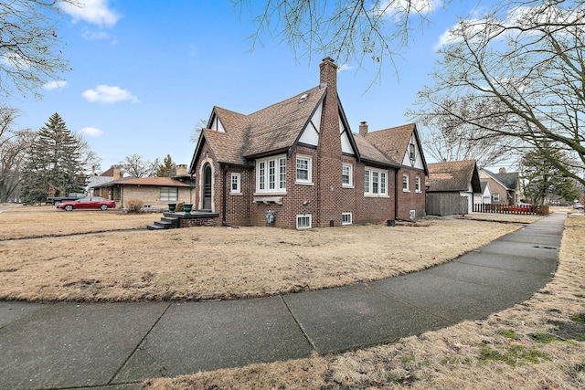 view of home's exterior featuring brick siding and a chimney