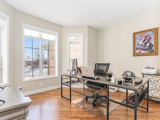 home office with baseboards and wood finished floors