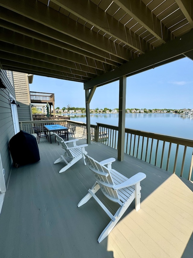 dock area with a deck with water view