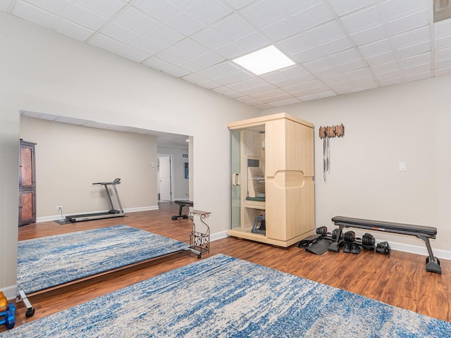 exercise area with baseboards and wood finished floors