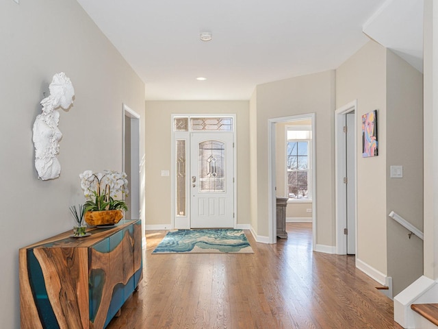 foyer entrance featuring baseboards and wood finished floors