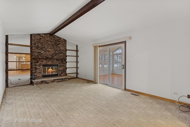 unfurnished living room with visible vents, baseboards, lofted ceiling with beams, carpet, and a brick fireplace