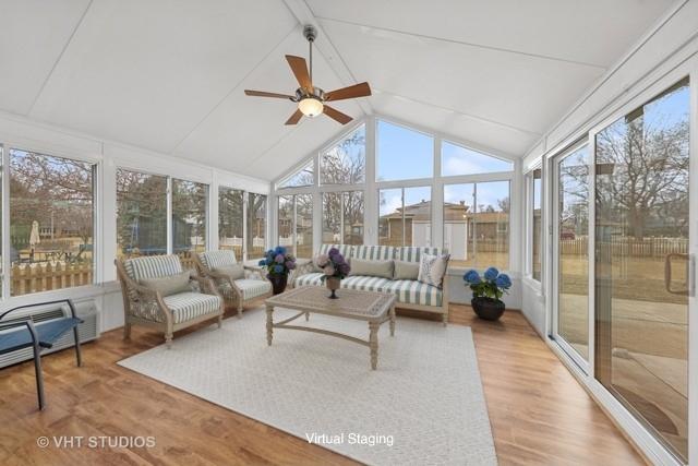 sunroom / solarium with lofted ceiling with beams and a ceiling fan