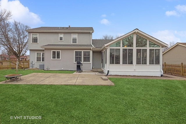 back of property with an outdoor fire pit, a sunroom, a patio, and fence