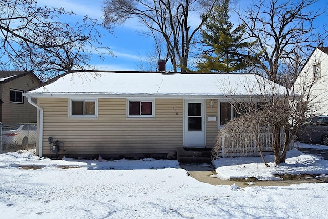 ranch-style house featuring entry steps and fence