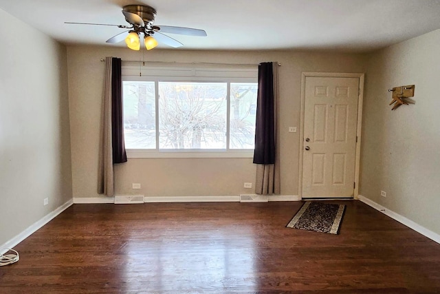 entryway with baseboards, visible vents, and dark wood finished floors