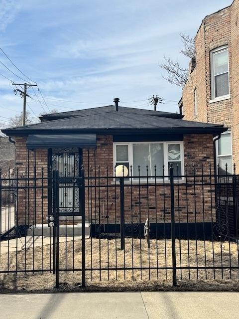 view of gate with a fenced front yard