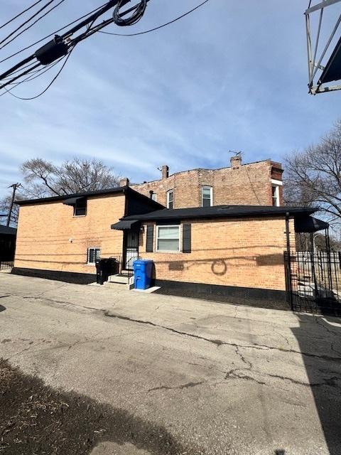 view of property exterior with brick siding