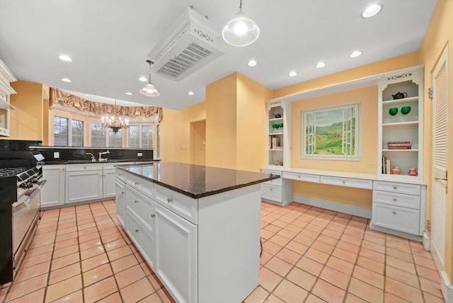 kitchen featuring white cabinets, open shelves, built in desk, and gas stove