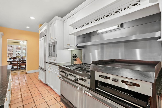 kitchen featuring light tile patterned floors, stainless steel appliances, tasteful backsplash, recessed lighting, and white cabinetry