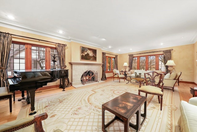 living room featuring crown molding, recessed lighting, a brick fireplace, wood finished floors, and baseboards