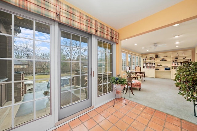 doorway to outside featuring carpet floors, tile patterned flooring, and recessed lighting