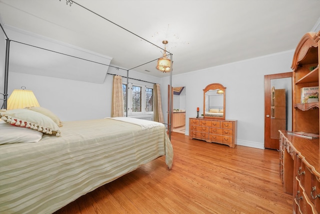 bedroom featuring light wood-type flooring, baseboards, and ornamental molding