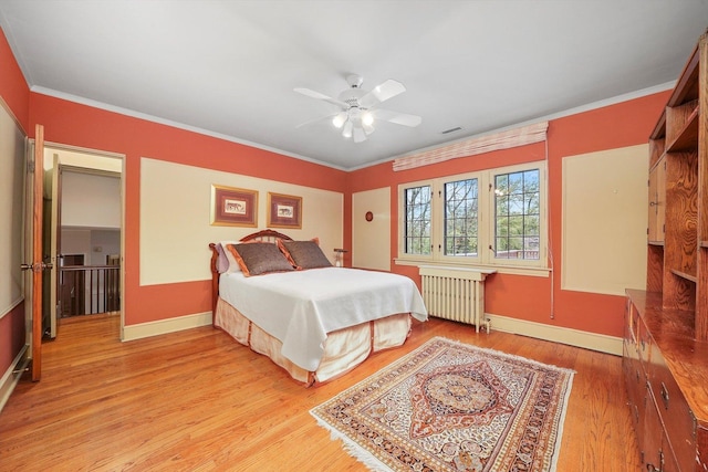 bedroom featuring visible vents, baseboards, radiator heating unit, ornamental molding, and light wood-type flooring