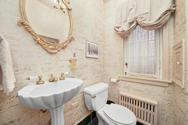 half bath featuring wallpapered walls, toilet, and radiator