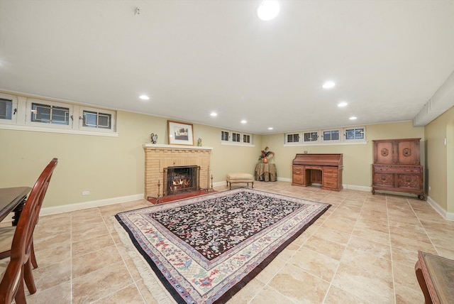 living area with a brick fireplace, light tile patterned flooring, baseboards, and recessed lighting