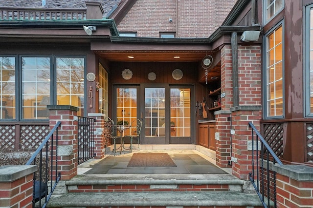 property entrance featuring brick siding