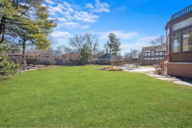 view of yard featuring fence and a patio