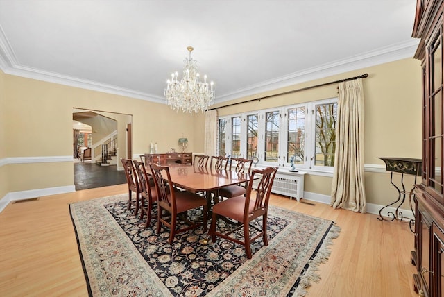 dining area with light wood finished floors, stairs, visible vents, and ornamental molding