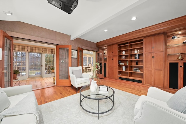 living room with light wood finished floors, beamed ceiling, and recessed lighting