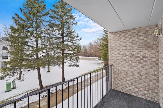 view of snow covered back of property