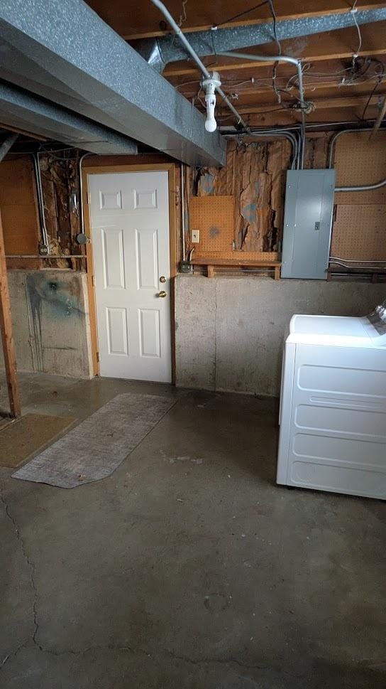 unfinished below grade area with washer / clothes dryer and electric panel