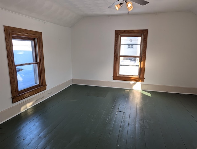 additional living space with lofted ceiling, ceiling fan, dark wood-style floors, and baseboards