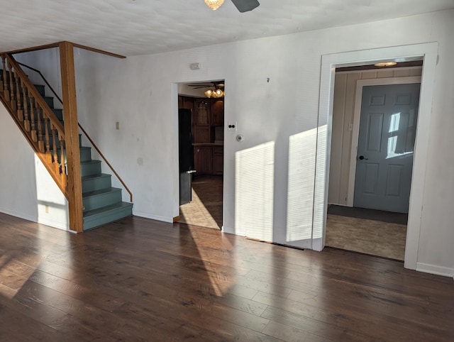 unfurnished room with a ceiling fan, stairway, and hardwood / wood-style floors