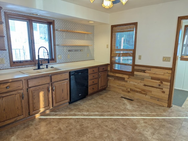 kitchen featuring black dishwasher, visible vents, brown cabinets, open shelves, and a sink