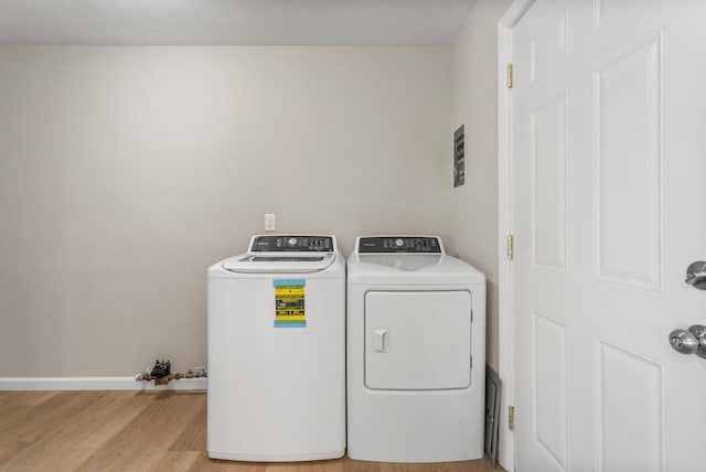 laundry room featuring laundry area, light wood-style flooring, and independent washer and dryer