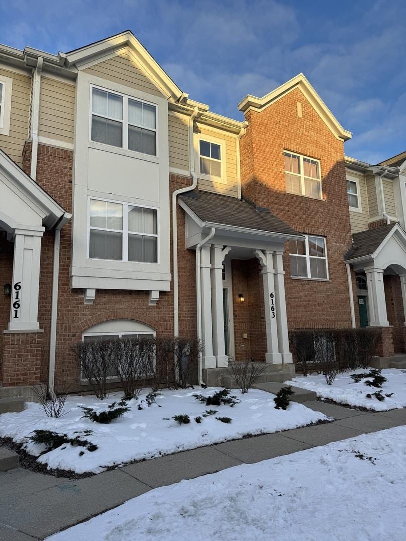 townhome / multi-family property featuring brick siding