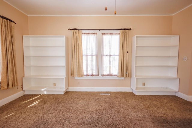 unfurnished room with carpet, baseboards, and crown molding