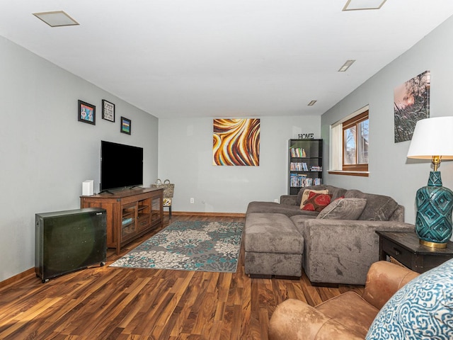 living area featuring wood finished floors and baseboards