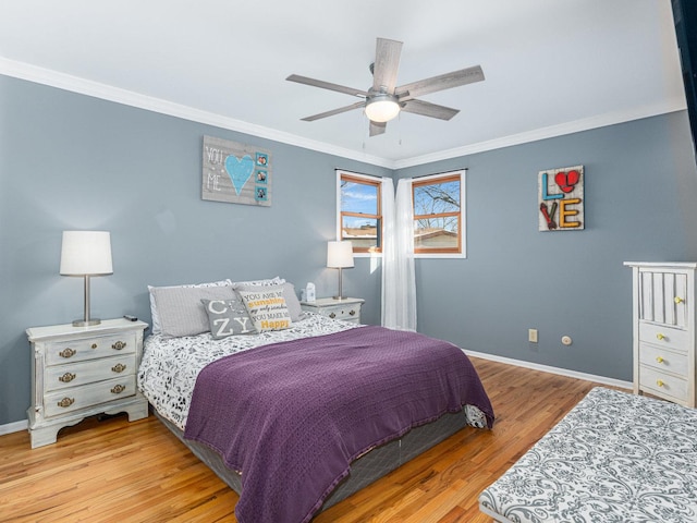 bedroom with ceiling fan, ornamental molding, light wood-style flooring, and baseboards