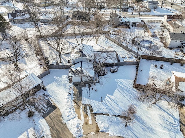 snowy aerial view with a residential view