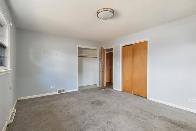 unfurnished bedroom featuring carpet floors, visible vents, and baseboards