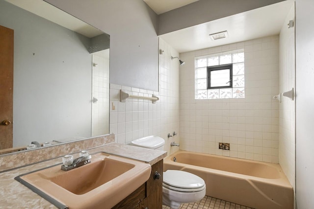 bathroom with toilet, visible vents, vanity, shower / washtub combination, and tile patterned floors