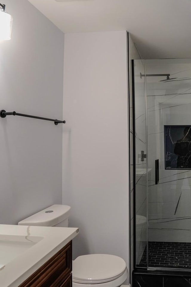 full bath with toilet, a stall shower, and vanity