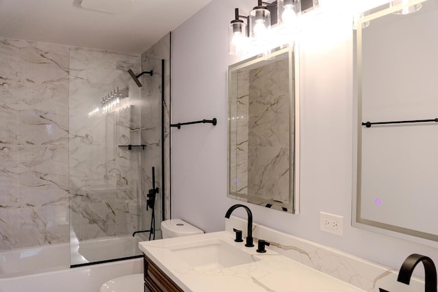 bathroom with combined bath / shower with glass door, vanity, and toilet