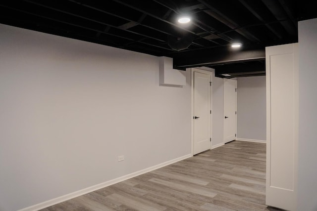 finished basement with baseboards and wood finished floors