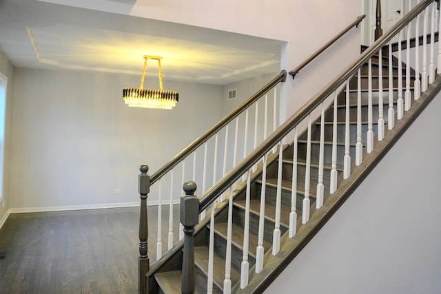 stairway with wood finished floors and baseboards